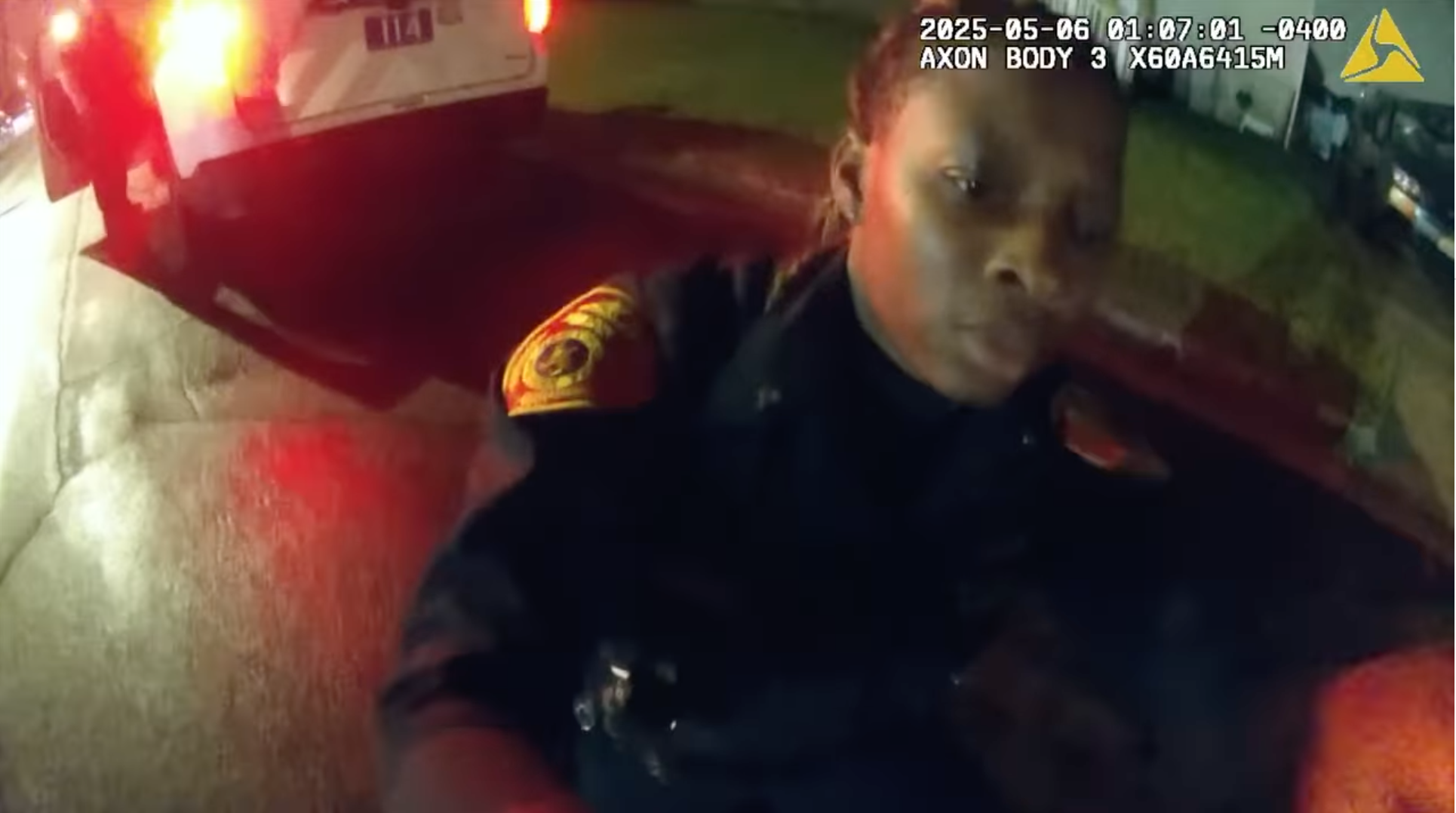 A fellow officer can be seen applying a tourniquet to the officer's injured leg.
